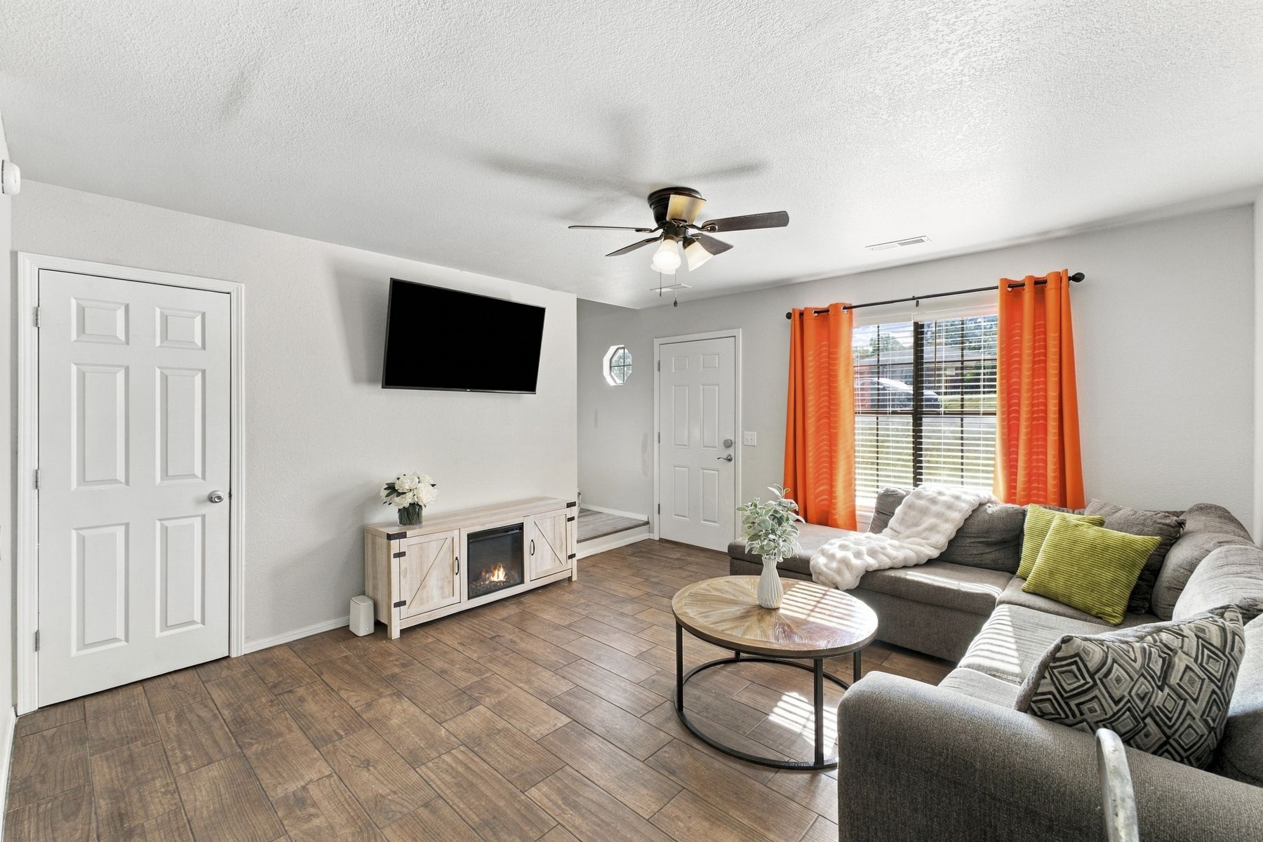 Unit A living room with sectional and electric fireplace