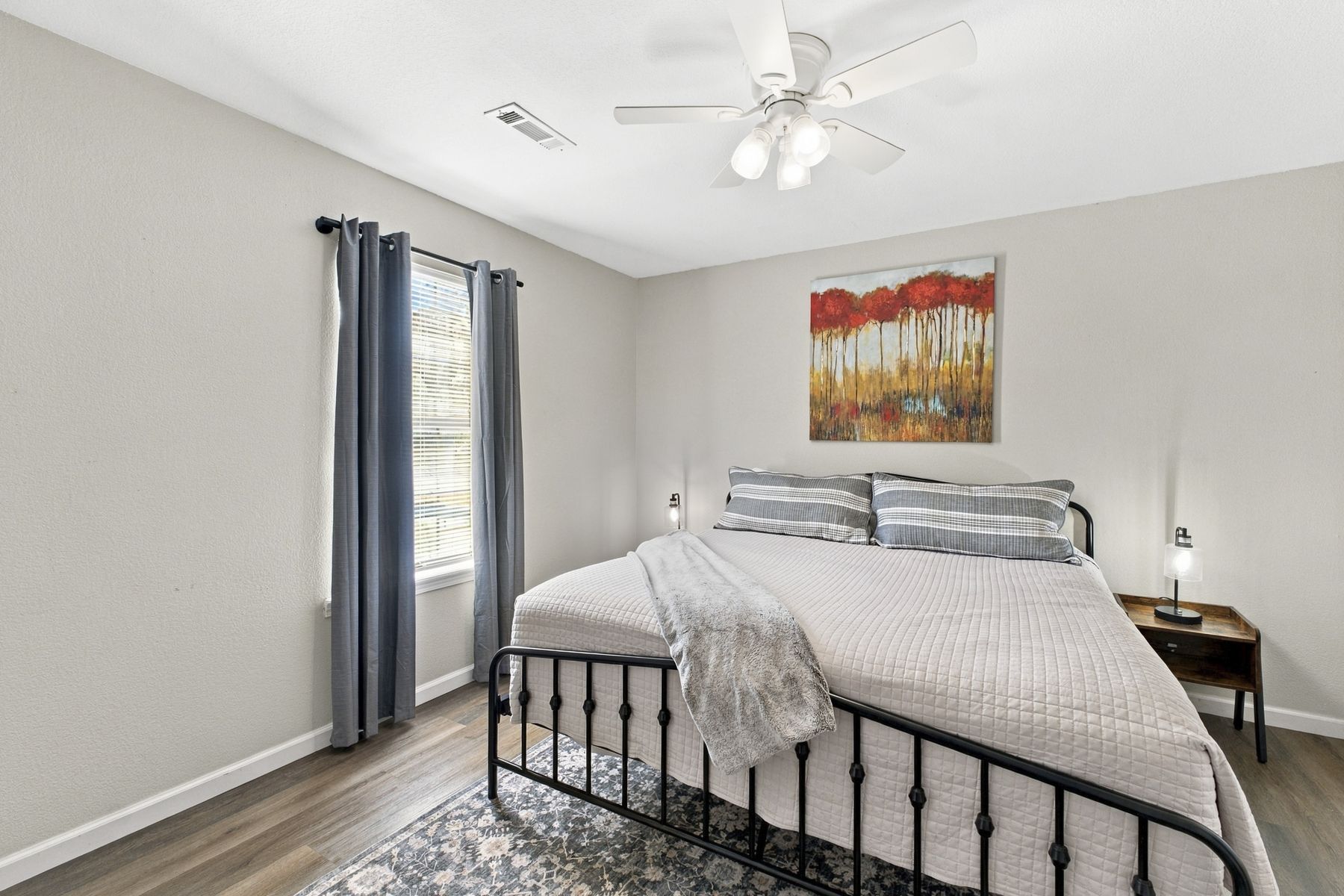 Unit B bedroom with king bed and artwork