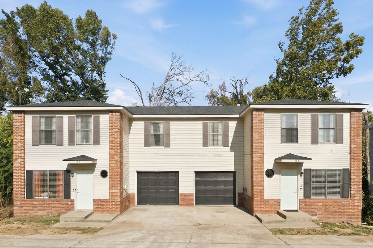 Front of the 10 Jonquilla Way duplex: two brick-and-siding homes with attached garages